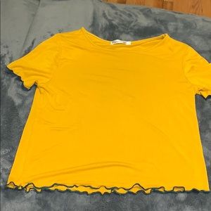 mustard shirt, with dark green ruffles